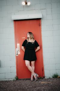 Amanda Grace posing by a red door