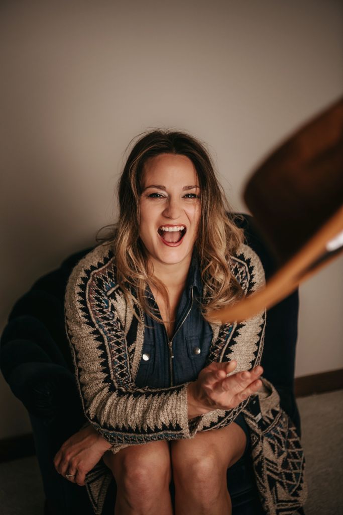 Amanda Grace laughing in a studio portrait