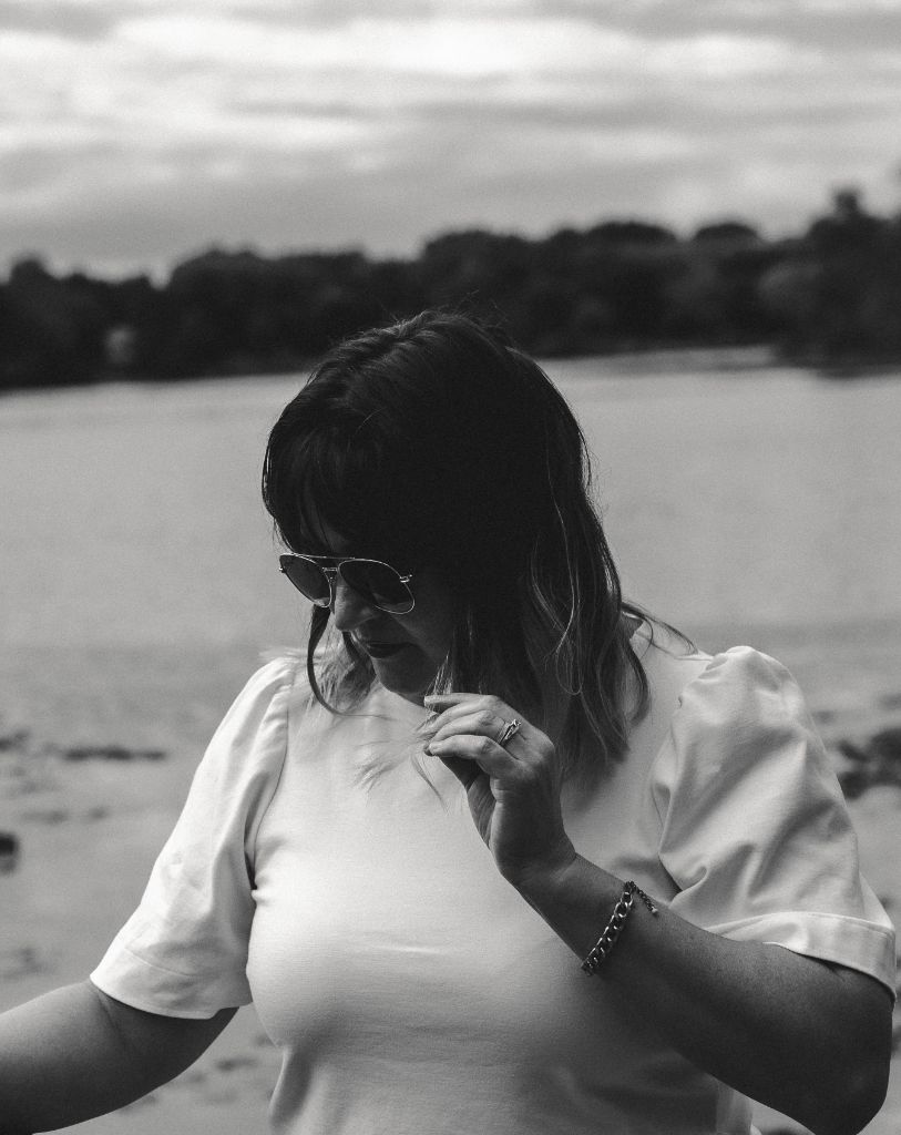 Amanda Grace in sunglasses outdoors, black and white